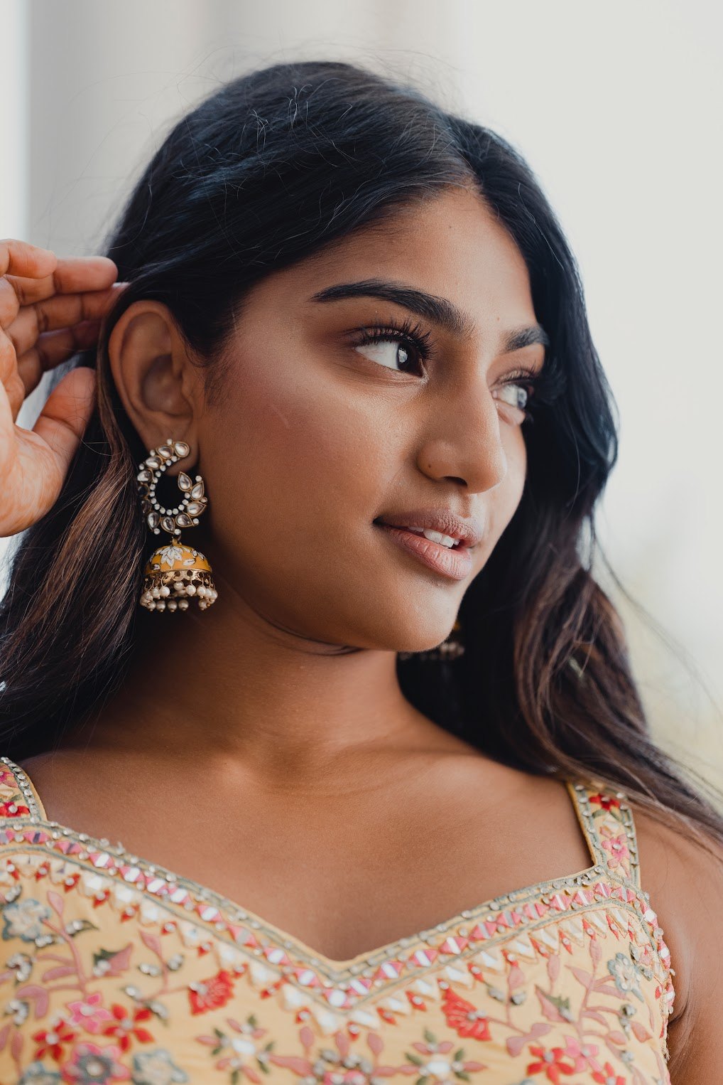 Close beauty portrait of Mahika Valluri in jhumka earrings and a yellow embroidered blouse